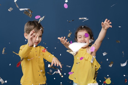 deux enfants sous des confettis